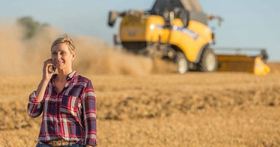 Woman in grain field on a call